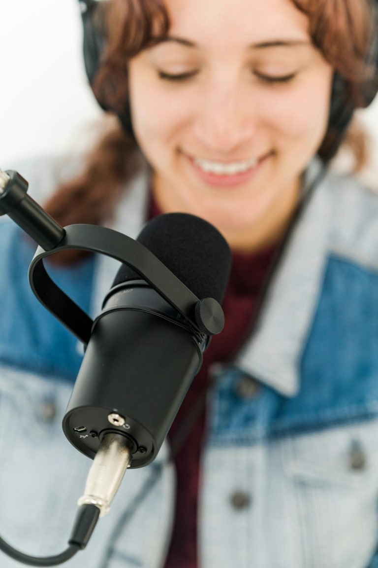 woman at a podcasting microphone
